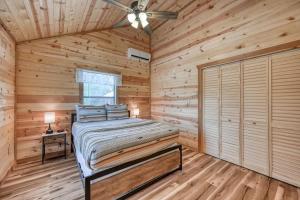 a bedroom with a bed in a log cabin at Rustic Cabin with Firepit and Grill - 10 mins to Main St in Rocky Hill