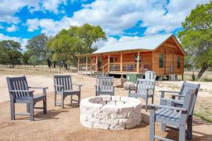 a group of chairs in front of a log cabin at Rustic Cabin with Firepit and Grill - 10 mins to Main St in Rocky Hill