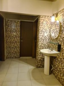 a bathroom with a sink and two mirrors at Couple room, attached balcony in Safipur