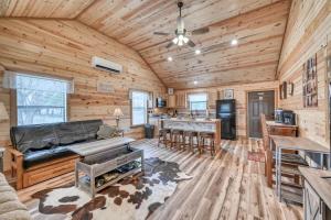 a living room with wooden walls and a ceiling at Rustic Cabin with Firepit and Grill - 10 mins to Main St in Rocky Hill