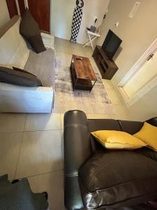 a living room with a couch and a coffee table at Primkop Cottage in White River