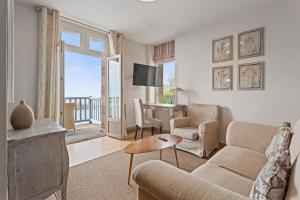 a living room with a couch and a table at Hotel Le Bellevue, Demeures & Chateaux in Villerville