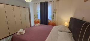 a bedroom with a bed with a purple bedspread at Bellevue in Podstrana +30 photos