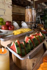 a buffet with watermelon and scrambled eggs and fruit at Alko Hotel Casa Nispero in Cali