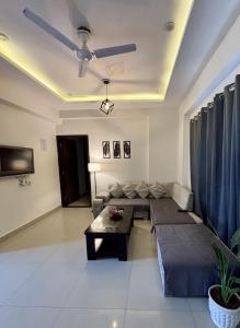 a living room with a couch and a table at The Huddle - Dusk in Dehradun