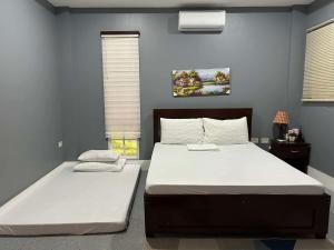 two beds in a bedroom with blue walls at Starksway Resort in San Juan