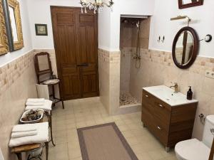 a bathroom with a shower and a toilet and a sink at Benafique La casa del Ciprés - refugio de calma en la Sierra de Huelva in Cortegana +26 photos