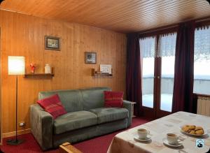 a living room with a couch and a table at Soldanella Cervinia apartment Vda Vacanze in Vetta CIR 0253 in Breuil-Cervinia