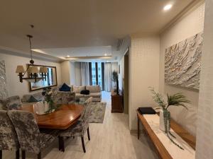 a dining room and living room with a table and chairs at Michelangelo Towers in Johannesburg