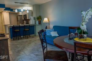 a living room with a blue couch and a table at Gulfview II #410 Luxe in South Padre Island