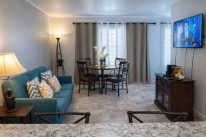 a living room with a blue couch and a table at Gulfview II #410 Luxe in South Padre Island
