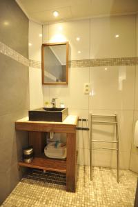 a bathroom with a sink and a mirror at Le Clos Sigebert in Libramont +11 photos