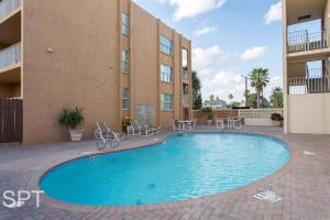 a swimming pool in front of a building at Fiesta Sol #110 in South Padre Island
