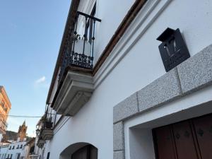 a balcony on the side of a building at Benafique La casa del Ciprés - refugio de calma en la Sierra de Huelva in Cortegana
