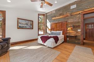 a bedroom with a bed and a wooden wall at Grizzly Bear Creek- Mt Rushmore Views- Hot tub in Keystone