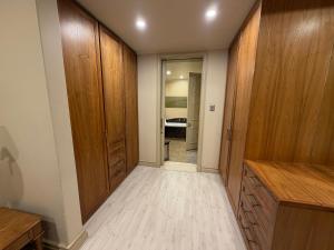 an empty hallway with wooden cabinets and a bedroom at Michelangelo Towers in Johannesburg +6 photos