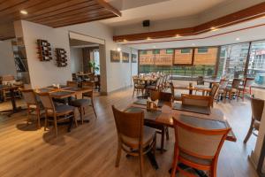 a dining room with wooden tables and chairs at Hotel Don Luis Puerto Montt in Puerto Montt