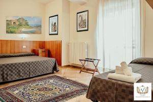 a hotel room with two beds and a rug at Nazareth Residence in Viterbo +90 photos