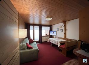 a living room with a couch and a table at Soldanella Cervinia apartment Vda Vacanze in Vetta CIR 0253 in Breuil-Cervinia +42 photos