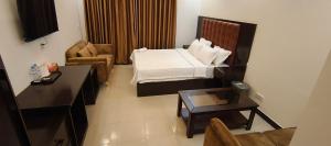 a small room with a bed and a table at Park Amaira Banani Guesthouse in Dhaka +13 photos