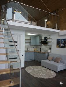 a loft conversion with a staircase and a living room at Vistachalet in Yablunytsya