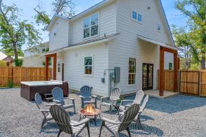 a backyard with chairs and a fire pit and a house at Rosé Retreat: Luxurious Getaway for 6, Hot Tub, Steps to Main Street in Fredericksburg