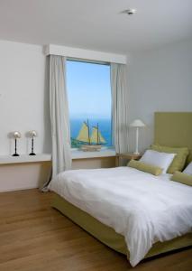 a bedroom with a large bed and a large window at Relais Blu in Massa Lubrense
