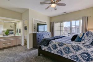 a bedroom with a bed and a sink and a mirror at Amazing 2 bed 2 bath with Gorgeous View in Branson