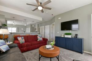 a living room with a red couch and a flat screen tv at Amazing 2 bed 2 bath with Gorgeous View in Branson