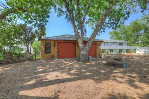 a house with a tree in the middle of a yard at Rojo-Charming unit walking distance to Main St! in Fredericksburg