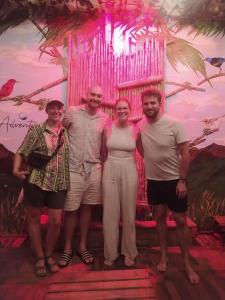 a group of people standing in front of a wall at ADVENTURE Hostel in San Gil