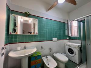 a bathroom with a sink and a washing machine at Villetta Capilungo by Paf in tour in Capilungo +17 photos
