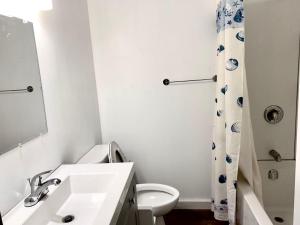 a white bathroom with a sink and a toilet at 8 Clarence Ln in Cavendish