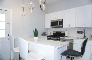 a kitchen with white cabinets and a white counter top at Basemant private room 21 in Guttenberg