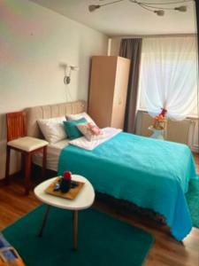 a small bedroom with a bed and a table at Happy M&S 2 in Šabac