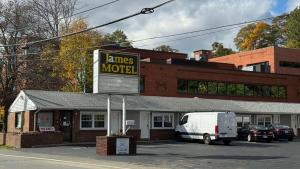 a kings motel with a van parked in a parking lot at James Motel in Saugus