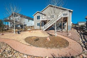 a house with a spiral staircase in a yard at Rangeview Pass Pet Friendly with Epic Peak Views in Monument
