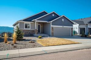 a house with a driveway in front of it at Rangeview Pass Pet Friendly with Epic Peak Views in Monument