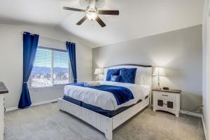 a bedroom with a bed and a ceiling fan at Rangeview Pass Pet Friendly with Epic Peak Views in Monument