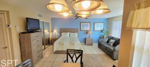 a bedroom with a bed and a couch in a room at Great Pool - Beach Access - Small Family Perfect in South Padre Island