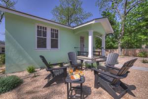 a patio with chairs and a table in front of a house at The Grove Combo in Fredericksburg