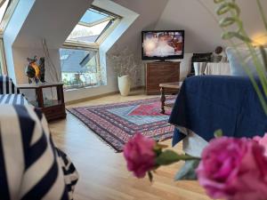 a living room with a couch and a tv at Soizic' house in Trébeurden