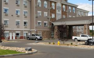 a parking lot in front of a large building at Canalta Wainwright in Wainwright