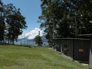 a building in a field with a view of the water at Valle de las Bendiciones, Lago Calima in Calima