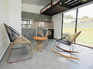 three chairs and a table in a kitchen at Valle de las Bendiciones, Lago Calima in Calima