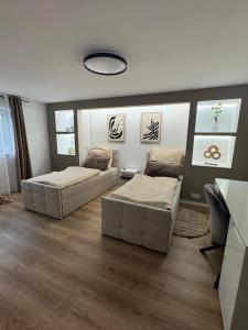 a living room with two beds and a couch at Elfis Paradise in Wiesbaden