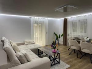 a living room with a white couch and a table at Elfis Paradise in Wiesbaden