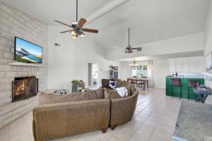 a living room with a couch and a fireplace at Casa Blanca: Hot-tub, Fire Pit, Hill Country Views in Luckenbach