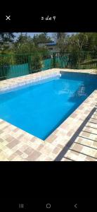 a large blue swimming pool with a fence at La Pantera in San Antonio de Arredondo