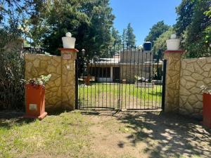 a gate in a yard with a stone fence at La Pantera in San Antonio de Arredondo